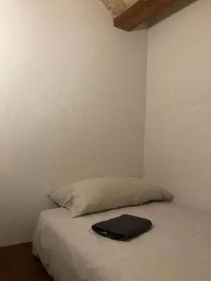 a black briefcase sitting on a bed in a room at Natural loft in Valencia