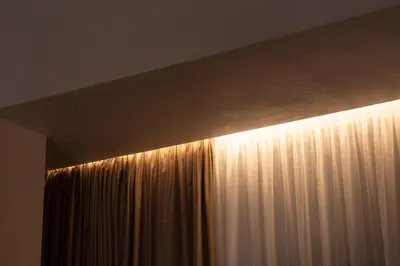 a light hanging from the ceiling next to a curtain at Natural loft in Valencia