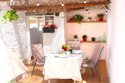 a dining room with a table and chairs at Casa Quintero Valencia Playa Cabañal in Valencia