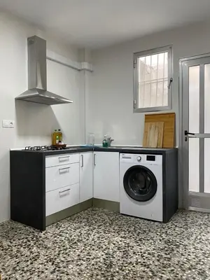 a kitchen with a washing machine and a stove at Casa Quintero Valencia Playa Cabañal in Valencia
