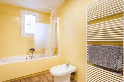 a bathroom with a toilet and a tub and a sink at Apartamento Ruzafa Centro II in Valencia