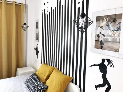a bedroom with a black and white striped wall at Harbor Apartments Valencia in Valencia
