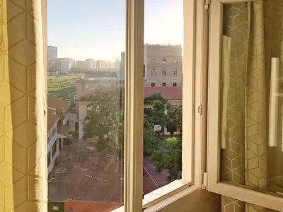 an open window with a view of a city at Harbor Apartments Valencia in Valencia