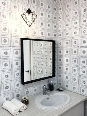 a bathroom with a sink and a mirror at Harbor Apartments Valencia in Valencia