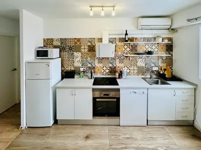 a kitchen with white cabinets and a white refrigerator at Harbor Apartments Valencia in Valencia