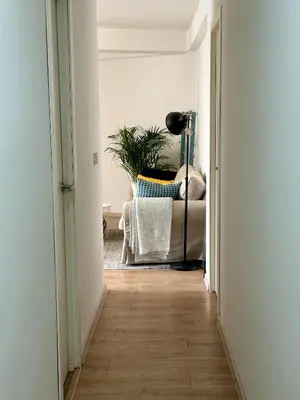 a hallway with a chair and a lamp in a room at Harbor Apartments Valencia in Valencia