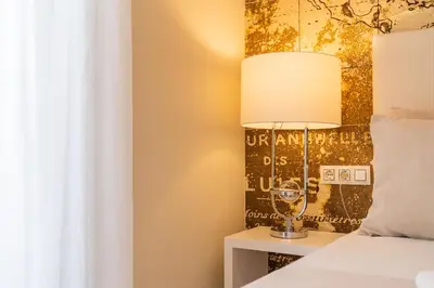 a bedroom with a bed and a lamp on a night stand at MD Puerto Rico in Valencia