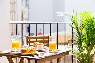 a table with two glasses of orange juice and croissants at MD Puerto Rico in Valencia