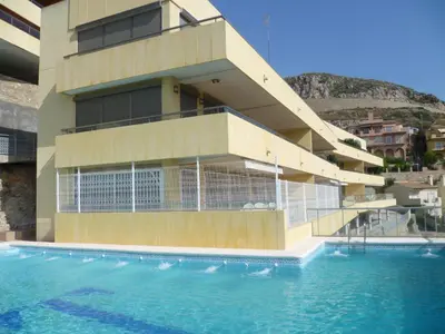 a building with a swimming pool in front of a building at Hetesa 2000, 3º-7 in Cullera