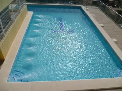 a large swimming pool with blue water at Hetesa 2000, 3º-7 in Cullera