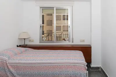 a bedroom with a bed and a window at EL RACO- C, 8-16 in Cullera