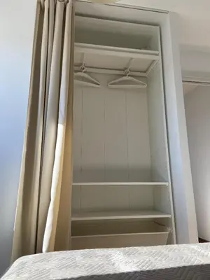 a closet with a curtain next to a bed at Europa A- 12º-23 in Cullera
