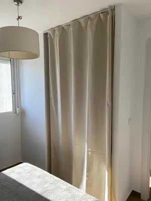 a bedroom with a bed with a curtain at Europa A- 12º-23 in Cullera