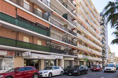 a city street with cars parked in front of buildings at Europa A- 12º-23 in Cullera