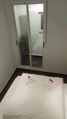 a small bed in a room with two lamps on tables at Casa Cosy in Valencia