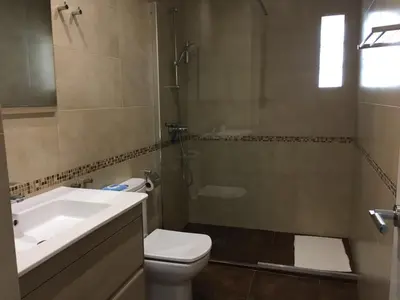 a bathroom with a sink and a toilet and a shower at Casa Cosy in Valencia