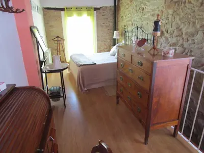 a bedroom with a bed and a dresser in a room at Ca'ls avis in Serra
