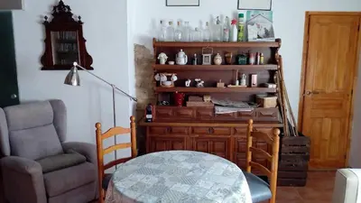 a living room with a chair and a table at Ca'ls avis in Serra