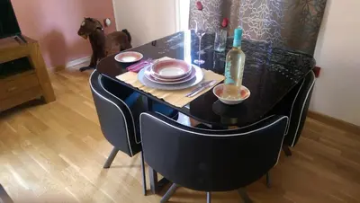 a black table with plates and a bottle of wine at Apartamento San Antonio in Sedaví