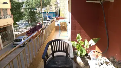 a bench sitting on the balcony of a building at Apartamento San Antonio in Sedaví