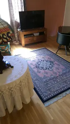 a living room with a table and a tv at Apartamento San Antonio in Sedaví