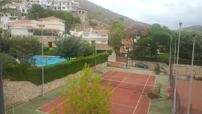 a tennis court in the middle of a city at Urbanización Cullera Park - Carmen y Jose in Cullera