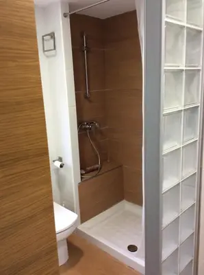 a bathroom with a shower and a toilet in it at Urbanización Cullera Park - Carmen y Jose in Cullera