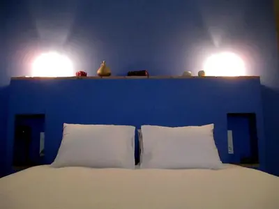 two lights above a bed with two white pillows at Sharíqua in Jérica