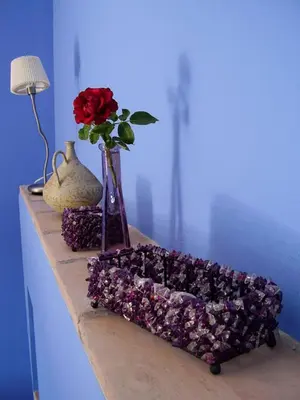 a table with a vase with a red rose and a vase with at Sharíqua in Jérica