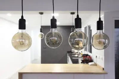 a kitchen with several glass lights hanging from the ceiling at 5 SENSES in Valencia