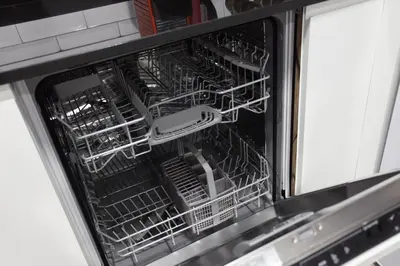an open dishwasher with a dish rack in it at 5 SENSES in Valencia