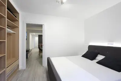 a bedroom with a bed and a walk in closet at 5 SENSES in Valencia