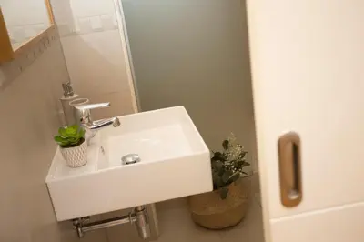 a white sink in a bathroom with a mirror at SingularStays Quevedo in Valencia