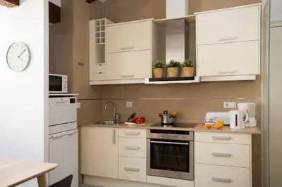 a kitchen with white cabinets and a sink at SingularStays Quevedo in Valencia