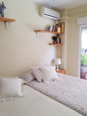 a bed with white sheets and pillows in a bedroom at Habitación privada a 1500 metros de la playa in Valencia