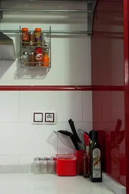 a kitchen counter with a shelf with jars of food at Homely Nest Valencia El Carme in Valencia