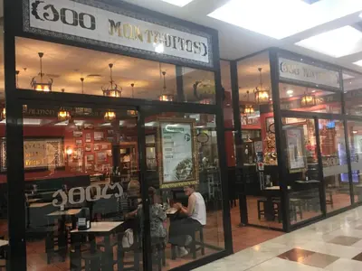 a man sitting at a table in a restaurant at Loft with terrace 24m2, swimming pool and garage in Chirivella