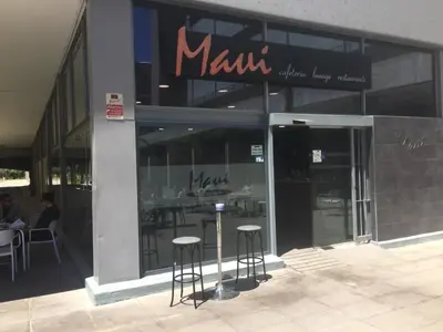 a restaurant with stools in front of a building at Loft with terrace 24m2, swimming pool and garage in Chirivella