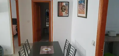 a table with a flower on it in a room at Apartamento Ciudad de las Ciencias 3 in Valencia