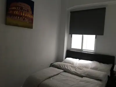 a small bedroom with a bed with a window at Apartamento Ciudad de las Ciencias 3 in Valencia