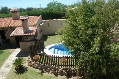 a backyard with a swimming pool and a house at Casa Tambor in Puebla de Vallbona