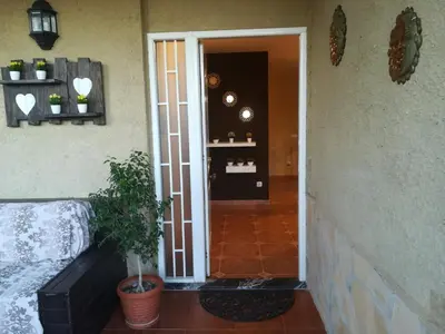 a door leading into a room with a plant next to it at Casa Tambor in Puebla de Vallbona