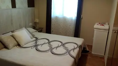 a white bed with a swirl design on it at Casa Tambor in Puebla de Vallbona