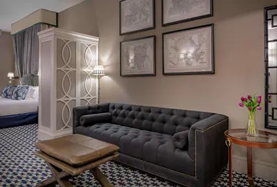 a living room with a couch and a bed at NH Collection Colón Valencia in Valencia