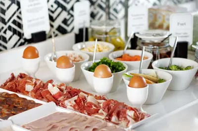a buffet with eggs and other food on a table at NH Collection Colón Valencia in Valencia