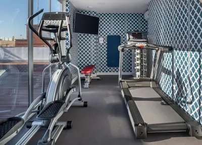 a gym with two treadmills and a treadmill at NH Collection Colón Valencia in Valencia