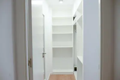 a room with white shelves and a door at Piso en La Ciudad de Artes in Valencia