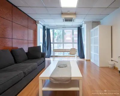 a living room with a couch and a table at Suites Rooms Valencia in Valencia