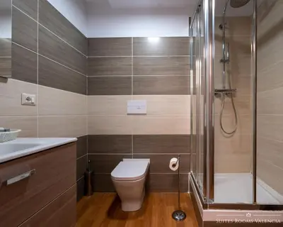 a bathroom with a shower and a toilet and a sink at Suites Rooms Valencia in Valencia