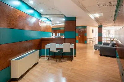 an office lobby with a table and chairs at Suites Rooms Valencia in Valencia